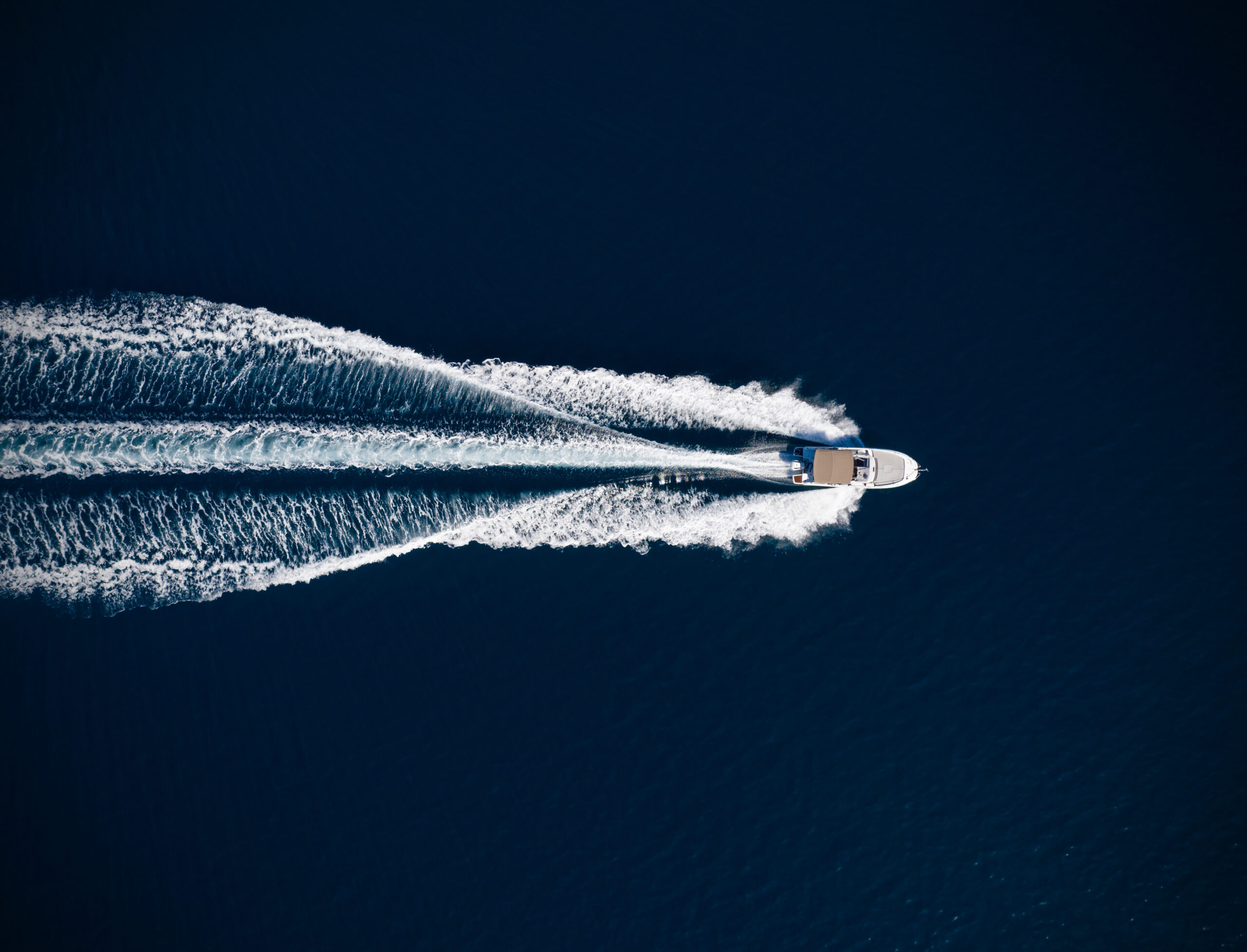 Aerial view of speed motor boat on open sea.