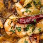 Sizzling hot prawns, drenched in olive oil with plenty of garlic and chilli