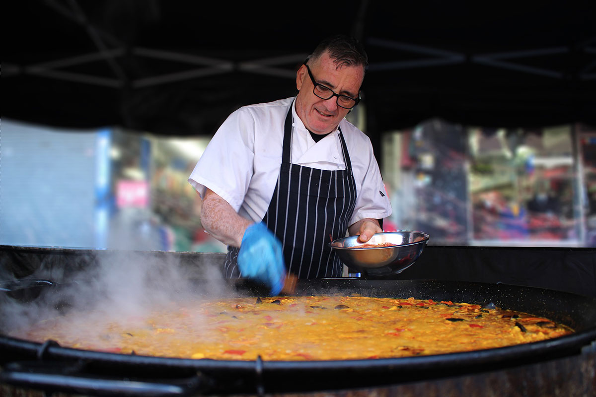 Chef checking a large Paella
