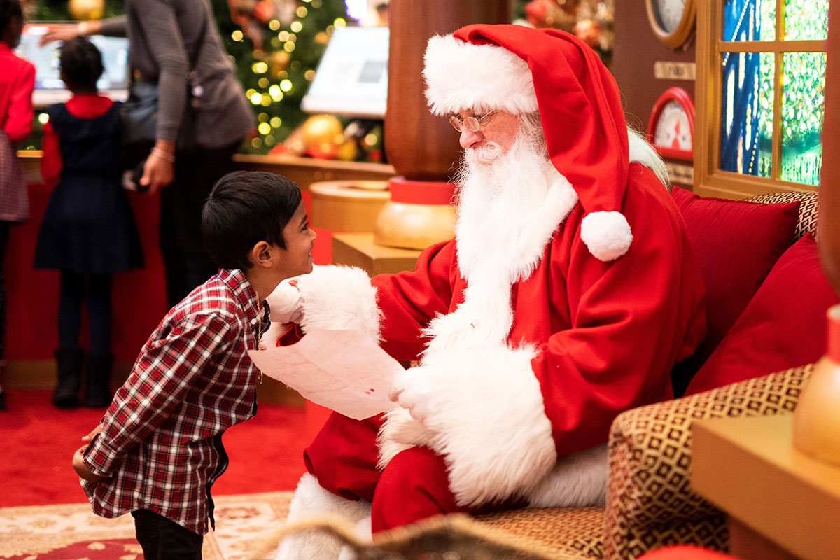 Father Christmas talking to a young boy